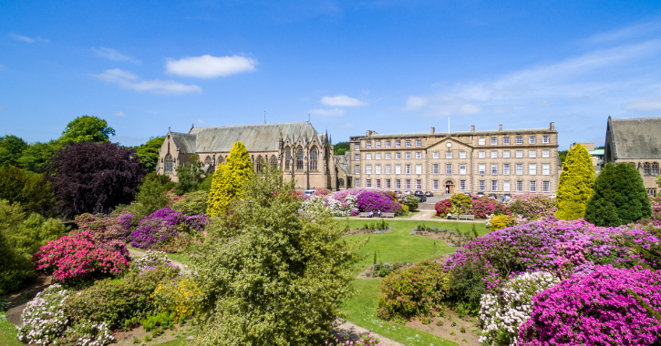 Areal view of Ushaw Historic House, Chapels and Gardens on a bright sunny day with blue skies overhead.